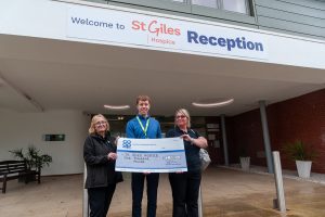 Sheila Villers (left), manager of Whittington Co-op, presents cheque to St Giles corporate partnerships officer Michael Dowse, with store supervisor Lorraine Brown looking on.