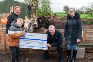 Karl Vyse presents Cash in the Bagh cheque to Polesworth Donkey Sanctuary